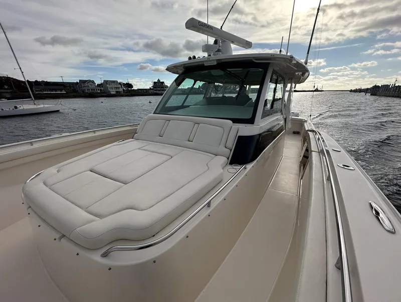 Slide: The Image of 2019 Grady-White Canyon boat on water, featuring spacious deck and sleek design. - 6