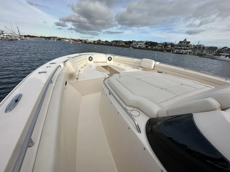 Slide: The Image of 2019 Grady-White Canyon boat on calm water, featuring spacious seating and sleek design. - 7