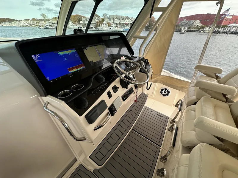 Slide: The Image of 2019 Grady-White Canyon boat interior with modern dashboard and steering wheel. - 8