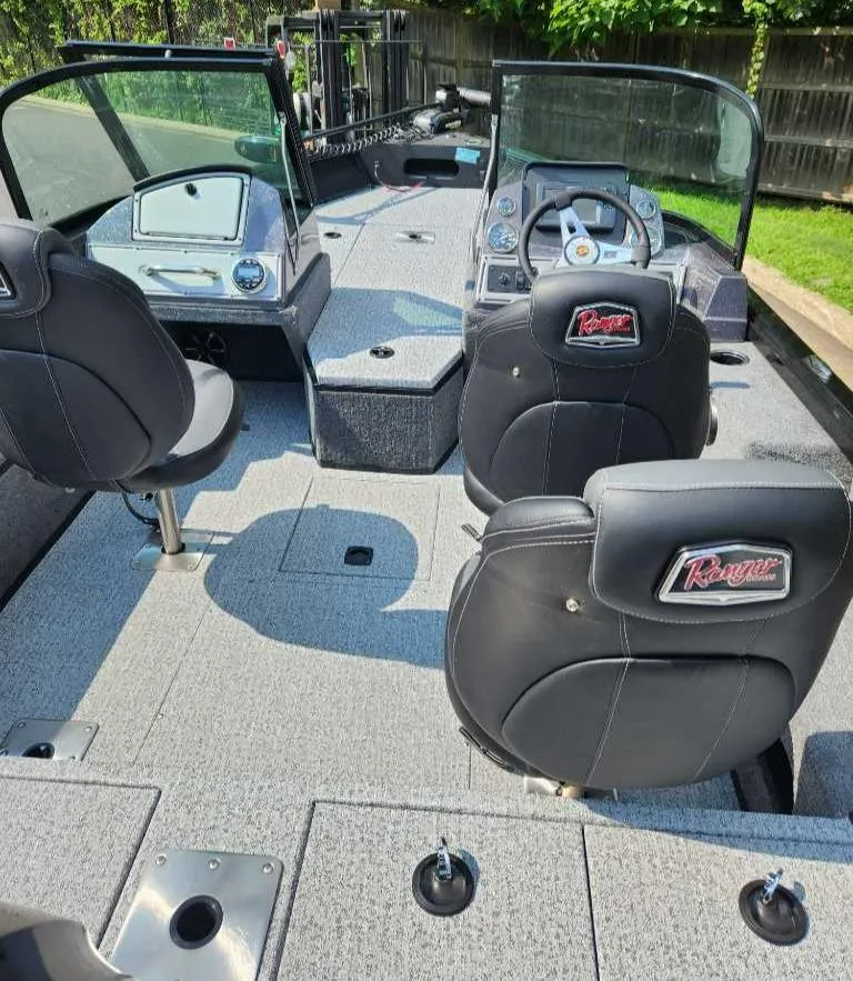 Slide: The Image of 2024 Ranger VS1682SC Angler boat interior with seating and steering console. - 2