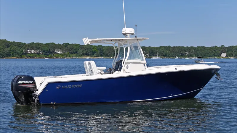 Slide: The Image of 2016 Sailfish 270 CC boat on calm water with Mercury outboard engine. - 0