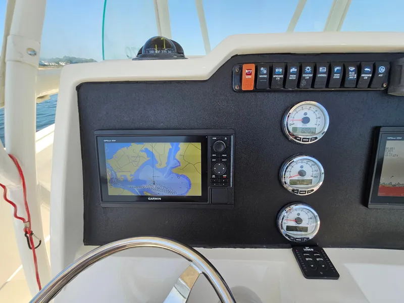 Slide: The Image of Dashboard of a 2016 Sailfish 270 CC boat with navigation and gauges. - 17