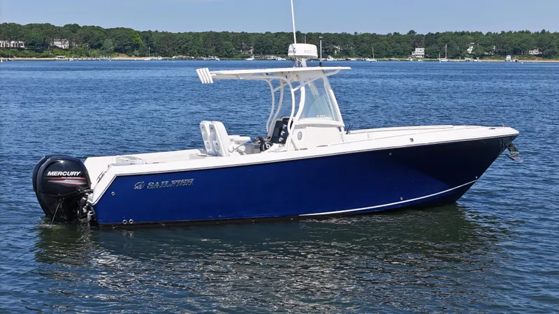 Slide: The Image of 2016 Sailfish 270 CC boat on calm water with Mercury outboard motor. - 2