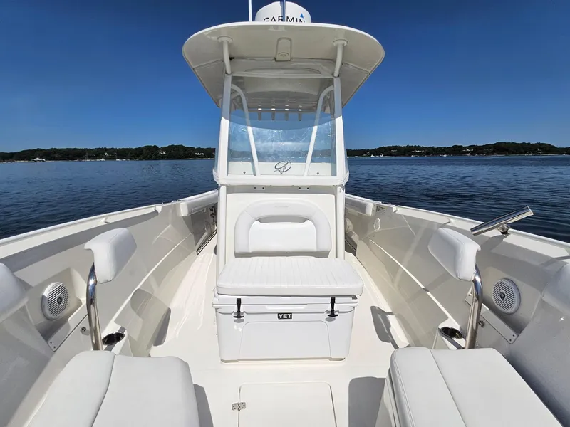 Slide: The Image of 2016 Sailfish 270 CC boat interior with seating, clear skies, and calm water. - 21