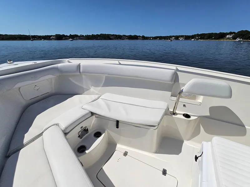 Slide: The Image of 2016 Sailfish 270 CC boat interior with white seating, on calm water. - 22