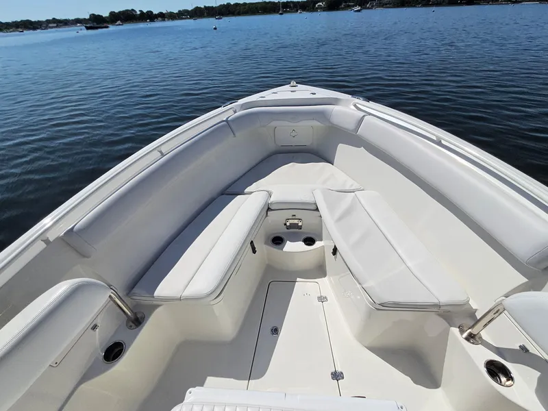 Slide: The Image of 2016 Sailfish 270 CC boat interior with white seating, on calm water. - 24