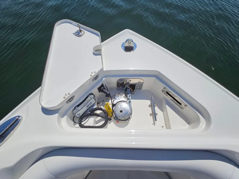 Slide: The Image of Bow storage compartment on a 2016 Sailfish 270 CC boat, featuring anchor and equipment. - 26
