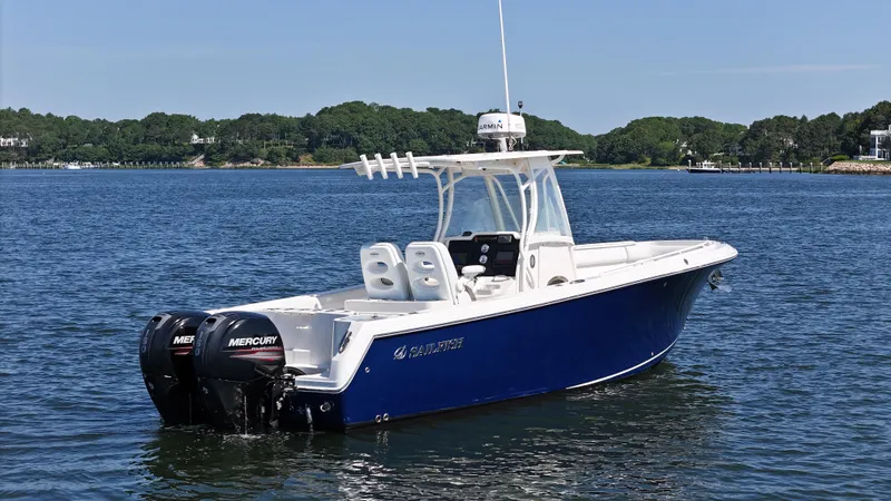 Slide: The Image of 2016 Sailfish 270 CC boat with twin Mercury engines on a calm lake. - 3