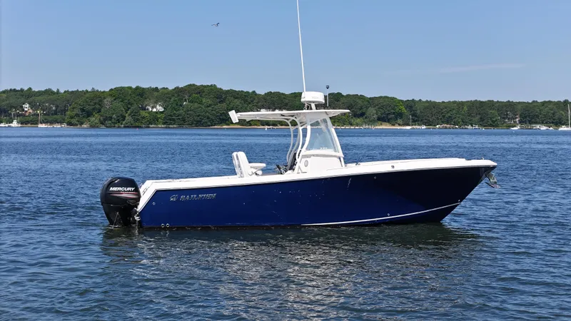 Slide: The Image of 2016 Sailfish 270 CC boat on calm water with scenic background. - 4