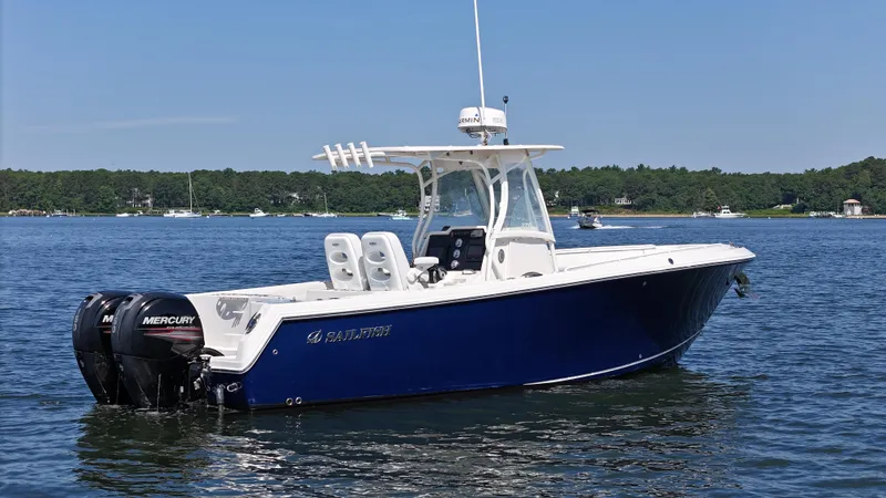 Slide: The Image of 2016 Sailfish 270 CC boat with twin Mercury engines on a calm lake. - 5