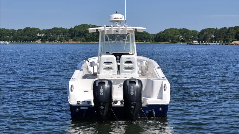 Slide: The Image of 2016 Sailfish 270 CC boat with dual 150 engines on a calm lake. - 6