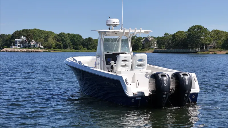 Slide: The Image of 2016 Sailfish 270 CC boat with dual Mercury engines on a scenic lake. - 7