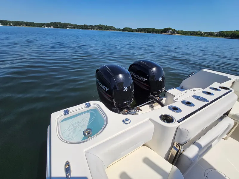 Slide: The Image of 2016 Sailfish 270 CC boat with dual Mercury engines on a calm lake. - 9