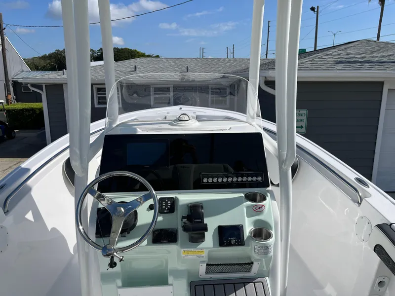 Slide: The Image of 2025 Tidewater 210 CC Adventure boat console with steering wheel and controls. - 4