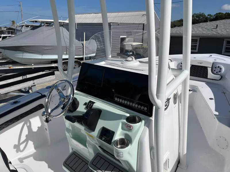 Slide: The Image of 2025 Tidewater 210 CC Adventure center console boat with modern dashboard and steering wheel. - 5