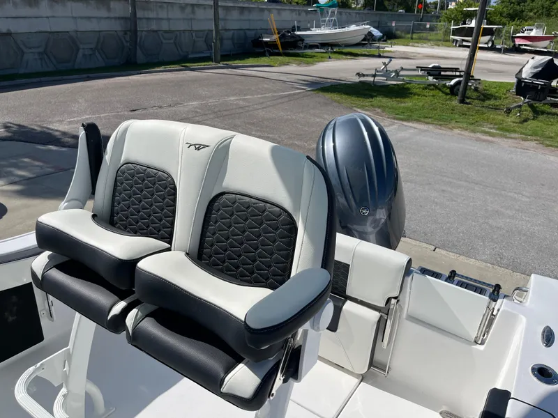 Slide: The Image of Tidewater 210 CC Adventure 2025 boat seats and engine in a marina. - 8