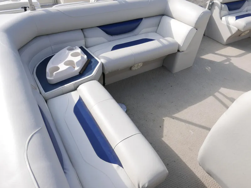 Slide: The Image of 2005 Sylvan Mirage 820 boat interior with white and blue seating. - 10