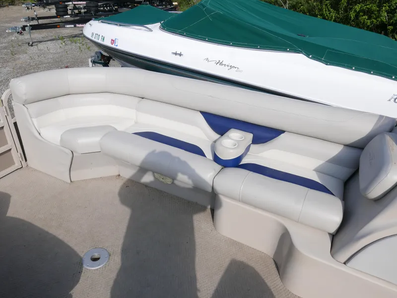 Slide: The Image of 2005 Sylvan Mirage 820 boat interior with white and blue seating. - 6