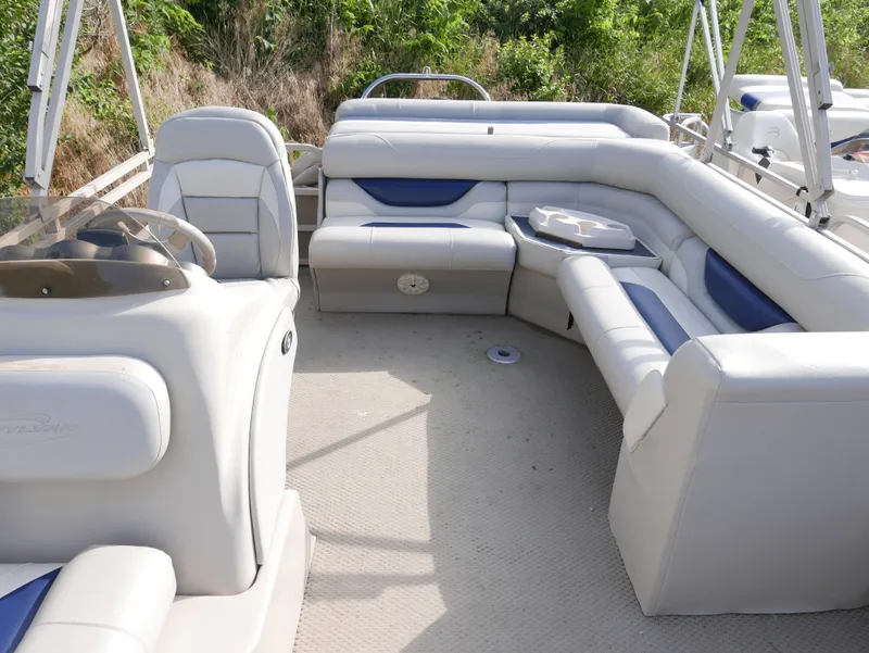 Slide: The Image of 2005 Sylvan Mirage 820 boat interior with spacious seating and table. - 7