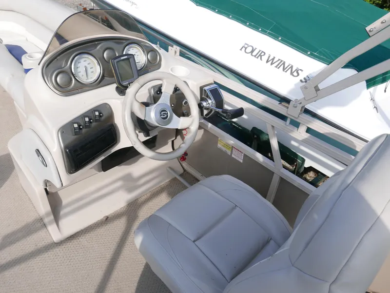 Slide: The Image of 2005 Sylvan Mirage 820 boat cockpit with steering wheel and control panel. - 8