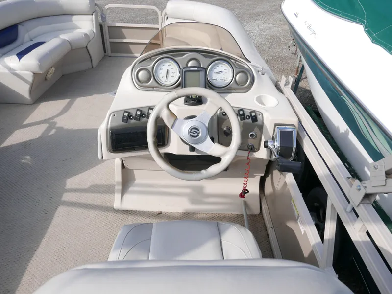 Slide: The Image of 2005 Sylvan Mirage 820 boat dashboard and steering wheel. - 9