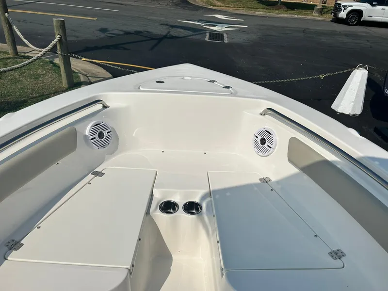 Slide: The Image of 2025 Key West 203 FS boat bow seating area with speakers and cup holders. - 6