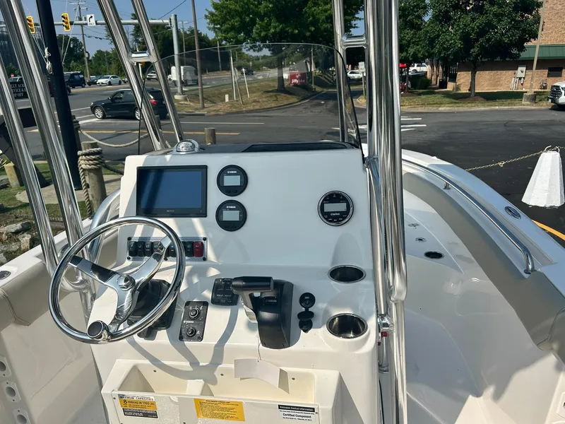 Slide: The Image of 2025 Key West 203 FS boat console with steering wheel and navigation controls. - 7