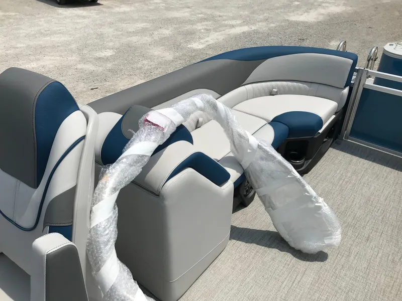 Slide: The Image of 2025 Avalon LSZ Quad Lounger boat cockpit with steering wheel and captain's chair. - 13