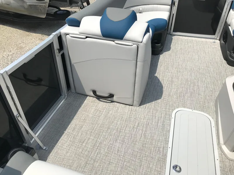Slide: The Image of 2025 Avalon LSZ Quad Lounger boat floor storage compartment with gray carpet. - 18