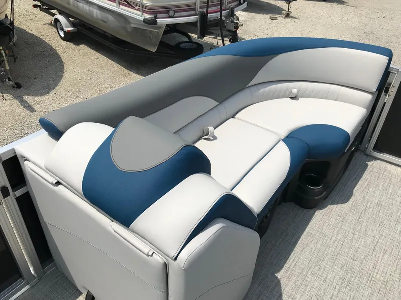 Slide: The Image of 2025 Avalon LSZ Quad Lounger boat interior with cup holder and storage compartment. - 21