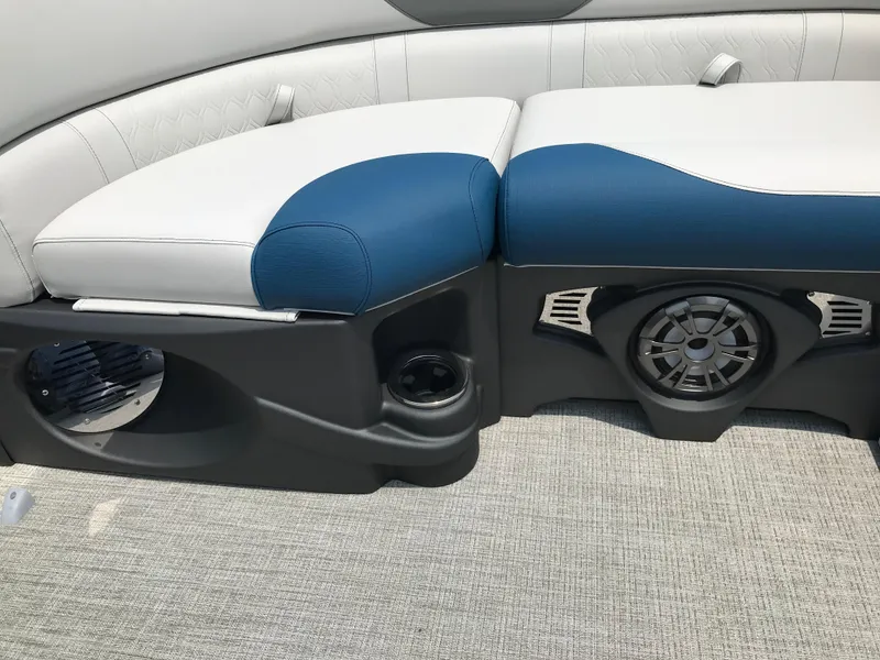 Slide: The Image of 2025 Avalon LSZ Quad Lounger boat interior with blue and white seating and built-in speaker. - 23