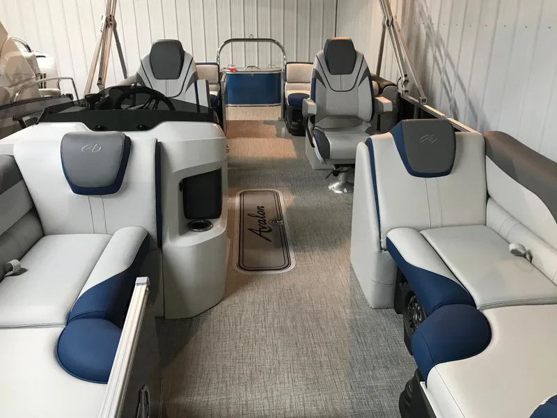 Slide: The Image of 2025 Avalon LSZ Quad Lounger boat seating with built-in speakers and cup holders. - 24