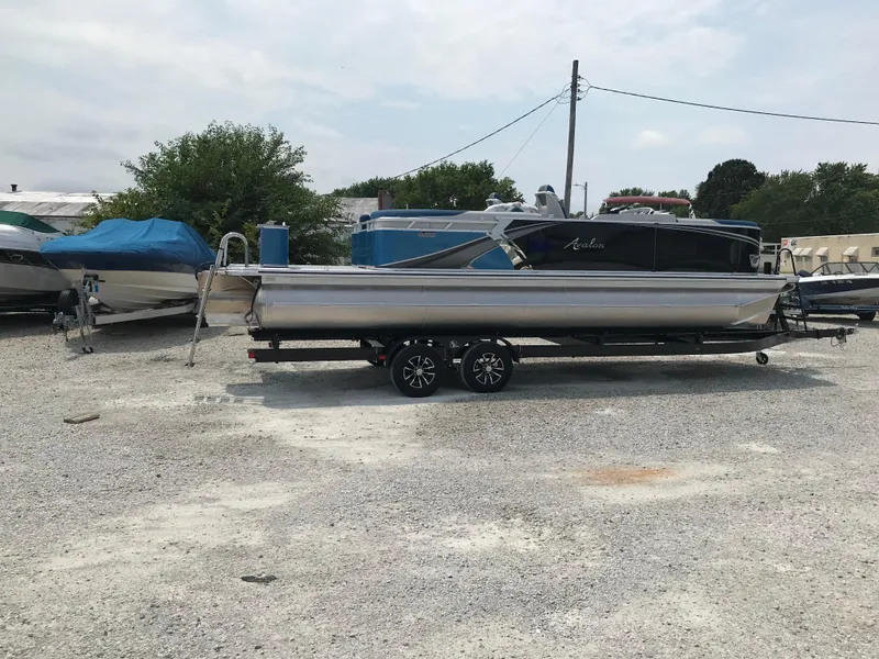Slide: The Image of 2025 Avalon LSZ Quad Lounger pontoon boat in showroom, featuring sleek design and modern amenities. - 3