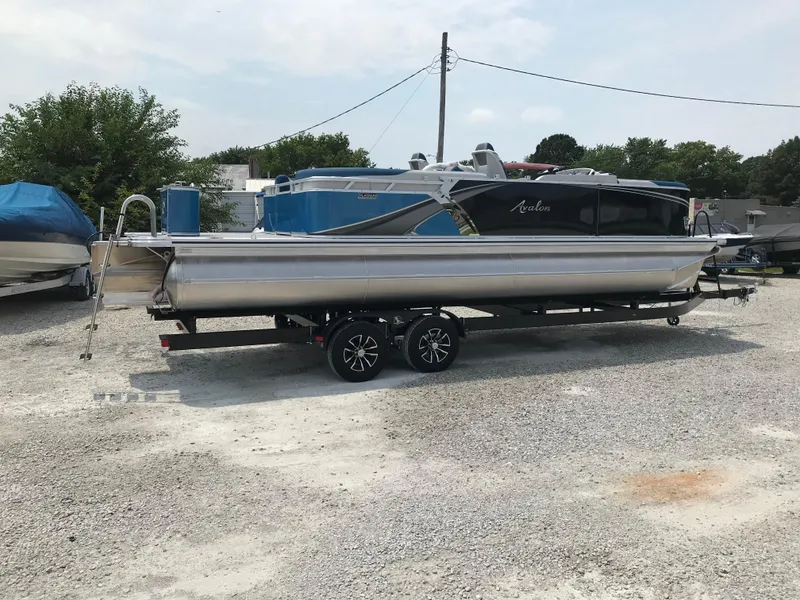 Slide: The Image of 2025 Avalon LSZ Quad Lounger pontoon boat on trailer, rear view. - 6