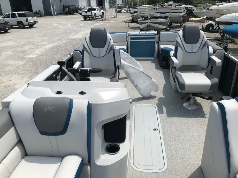 Slide: The Image of 2025 Avalon LSZ Quad Lounger pontoon boat on a trailer in a gravel lot. - 7