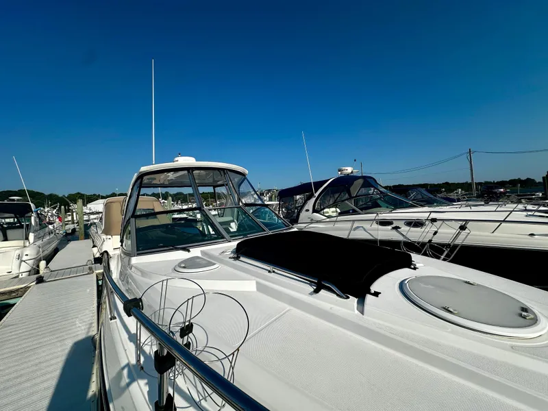 Slide: The Image of 2021 Monterey 335 Sport Yacht docked at marina under clear blue sky. - 10