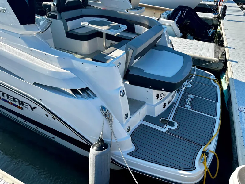Slide: The Image of 2021 Monterey 335 Sport Yacht docked, featuring spacious seating and modern design. - 11