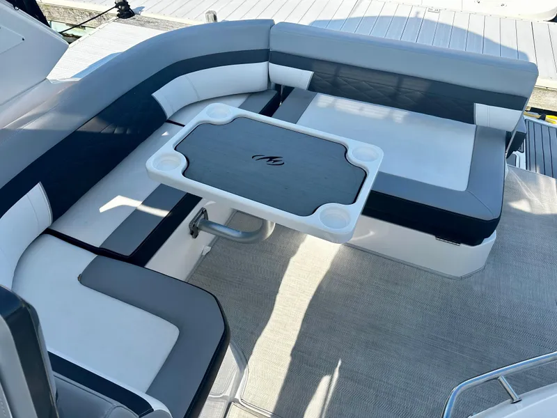 Slide: The Image of 2021 Monterey 335 Sport Yacht seating area with table, featuring modern design and comfortable upholstery. - 15