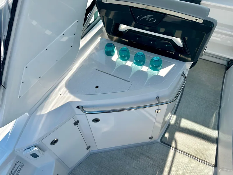 Slide: The Image of 2021 Monterey 335 Sport Yacht interior with sleek design and teal glasses on counter. - 16