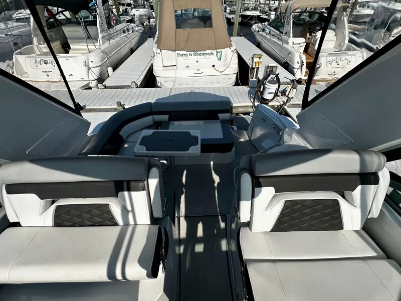 Slide: The Image of 2021 Monterey 335 Sport Yacht interior with seating and dock view. - 18