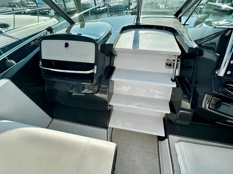 Slide: The Image of Interior view of 2021 Monterey 335 Sport Yacht, featuring sleek stairs and seating. - 19