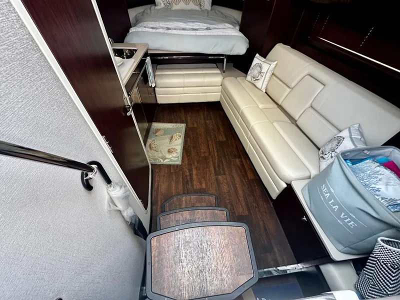Slide: The Image of Interior of 2021 Monterey 335 Sport Yacht with modern furnishings and wood flooring. - 23