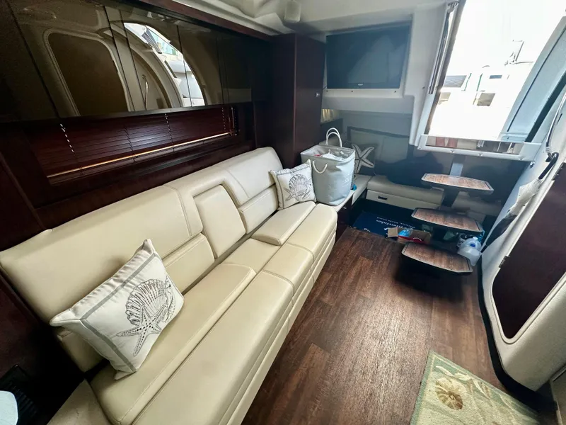 Slide: The Image of Interior of 2021 Monterey 335 Sport Yacht with beige seating and wooden flooring. - 24
