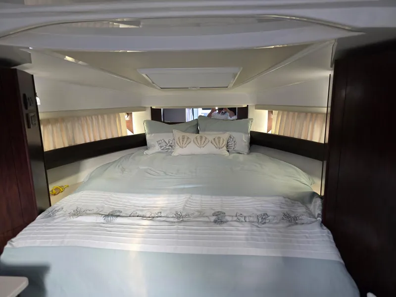 Slide: The Image of Interior cabin of 2021 Monterey 335 Sport Yacht with a cozy bed setup. - 28