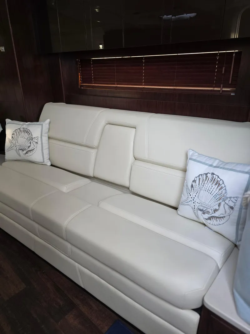 Slide: The Image of 2021 Monterey 335 Sport Yacht interior with elegant white leather seating and decorative pillows. - 29