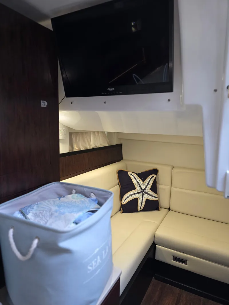 Slide: The Image of Interior of 2021 Monterey 335 Sport Yacht with cozy seating and starfish pillow. - 30