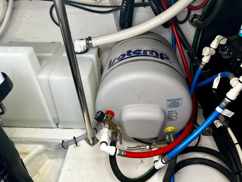 Slide: The Image of Engine room of 2021 Monterey 335 Sport Yacht with water heater and plumbing. - 37