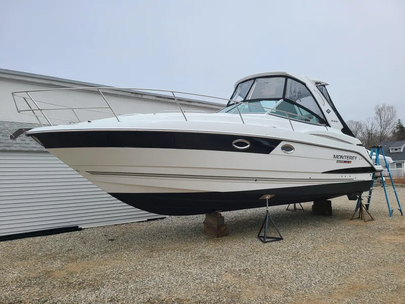 Slide: The Image of 2021 Monterey 335 Sport Yacht on dry dock, white hull, sleek design, parked outdoors. - 40