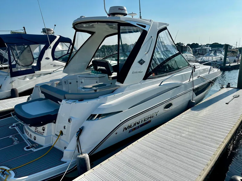 Slide: The Image of 2021 Monterey 335 Sport Yacht docked at marina, sleek design, sunny day. - 5