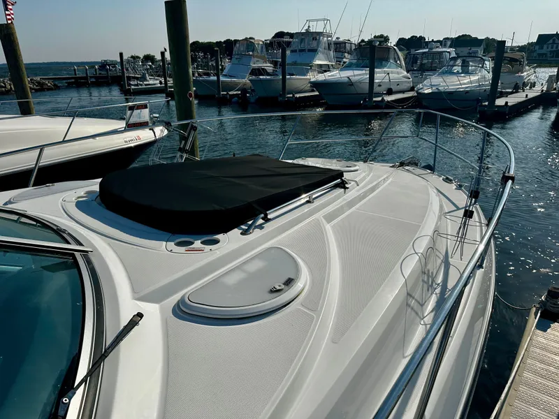 Slide: The Image of 2021 Monterey 335 Sport Yacht docked at a marina, surrounded by other boats. - 7